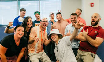 Eleven Quantum Workplace employees posing in the office.